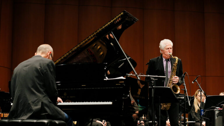 Pianist and Saxophonist playing together on stage.