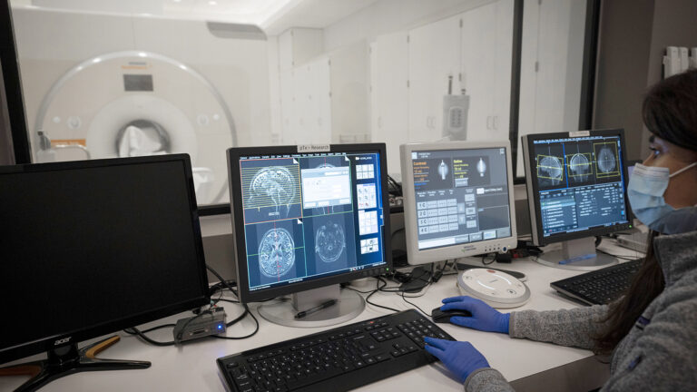 Researcher looks at the results of an MRI scan as it is happening.