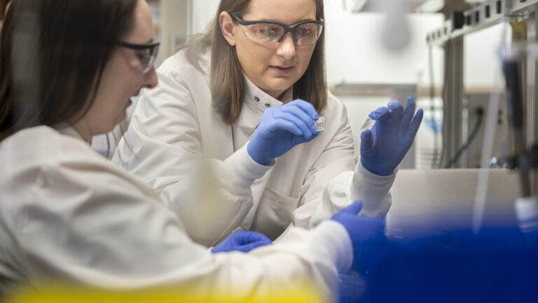 Two research looking at a sample together