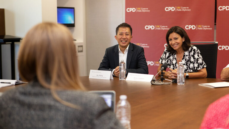 Individual interviewing a man and a women in conversation