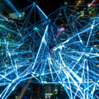 A graphic of light beams crossing each other.
