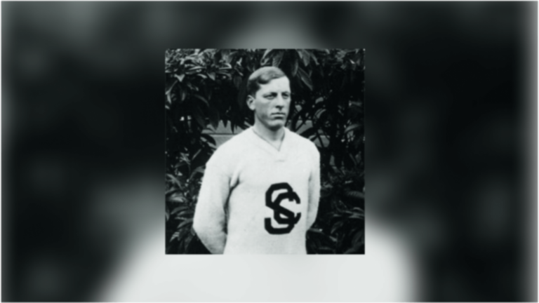 Emil Breitkreutz posing in front of the camera with his USC uniform