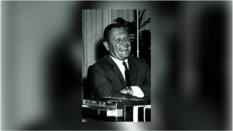 John R. Hubbard smiling in a suit.