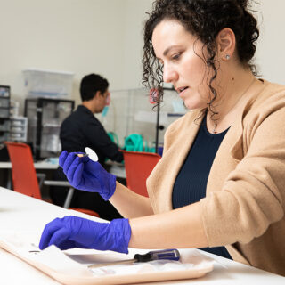 Rima Habre, MSc, ScD and Lisa Valencia work in the Soto Street wet lab and perform air monitoring activities as part of environmental health research.