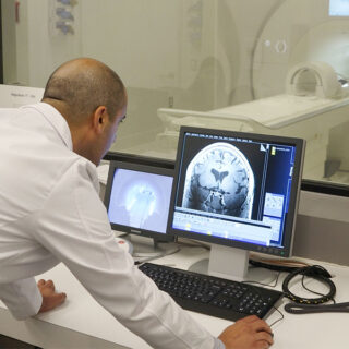 A doctor looking at a scan on an MRI scanners.