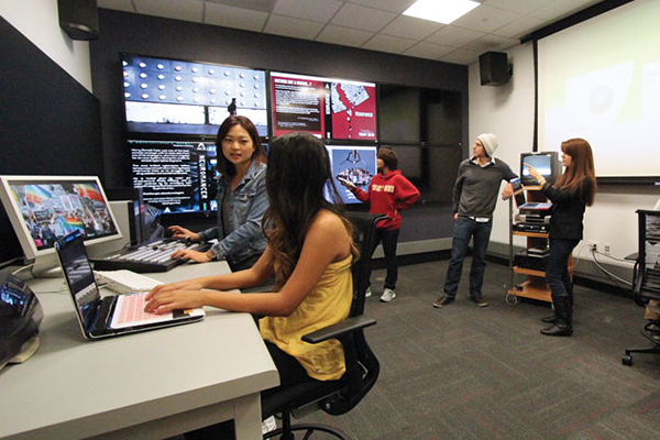 USC Media Arts and Practice students sit at computers and collaborate at the USC School of Cinematic Arts.