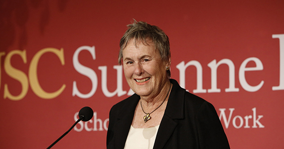 Suzanne Dworak-Peck on the podium in front of the microphone