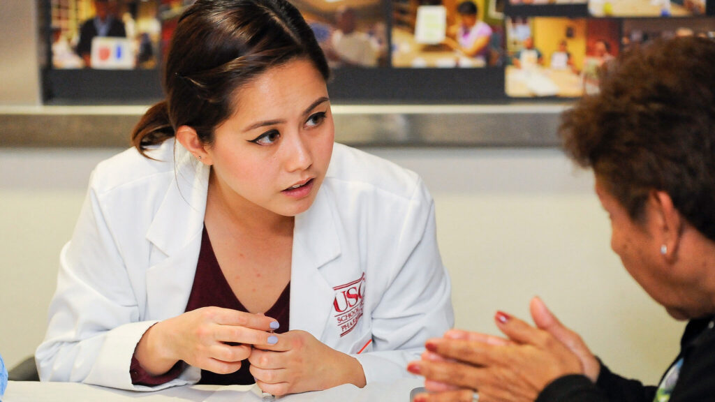 USC Pharmacy student talking with a patient