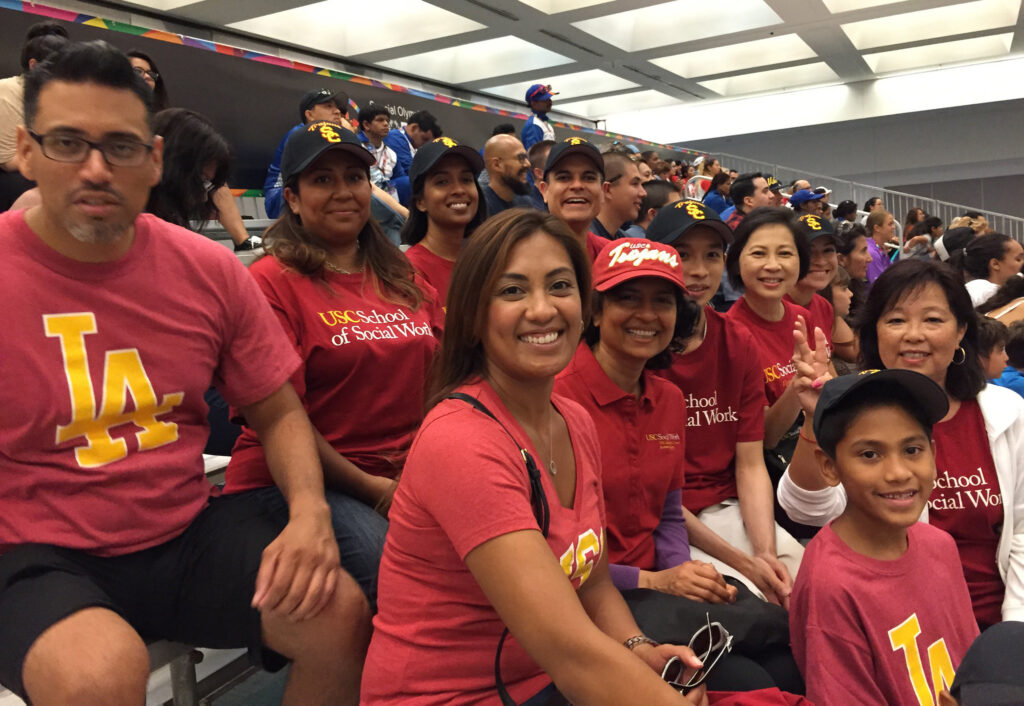 Social Work community wearing USC garb and sitting in bleachers