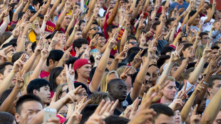 USC students raise the Victory sign during a spirit rally