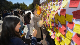 USC students add messages to a board celebrating first-generation college students.