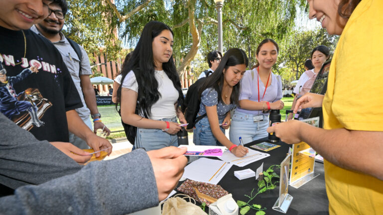 students signing up at a booth